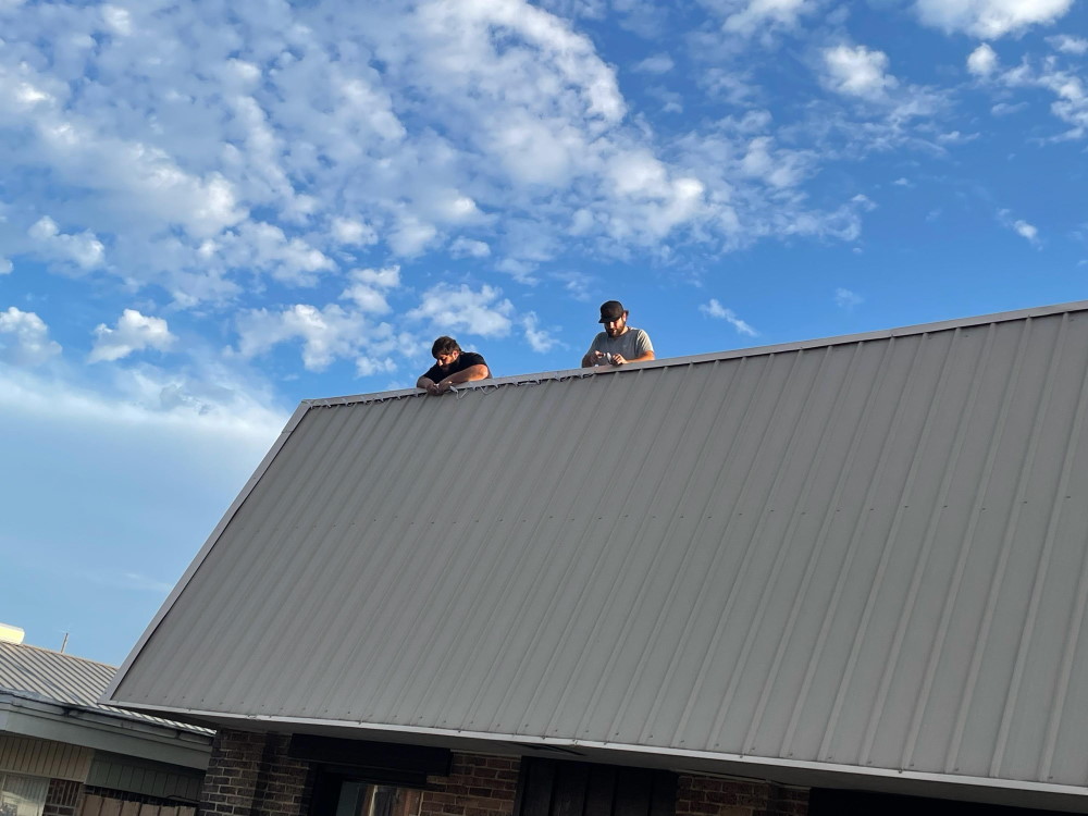 2 of the Stephens brothers up on the roof of a downtown building installing Christmas Lights for 2021 2 of the Stephens brothers up on the roof of a downtown building installing Christmas Lights for 2021