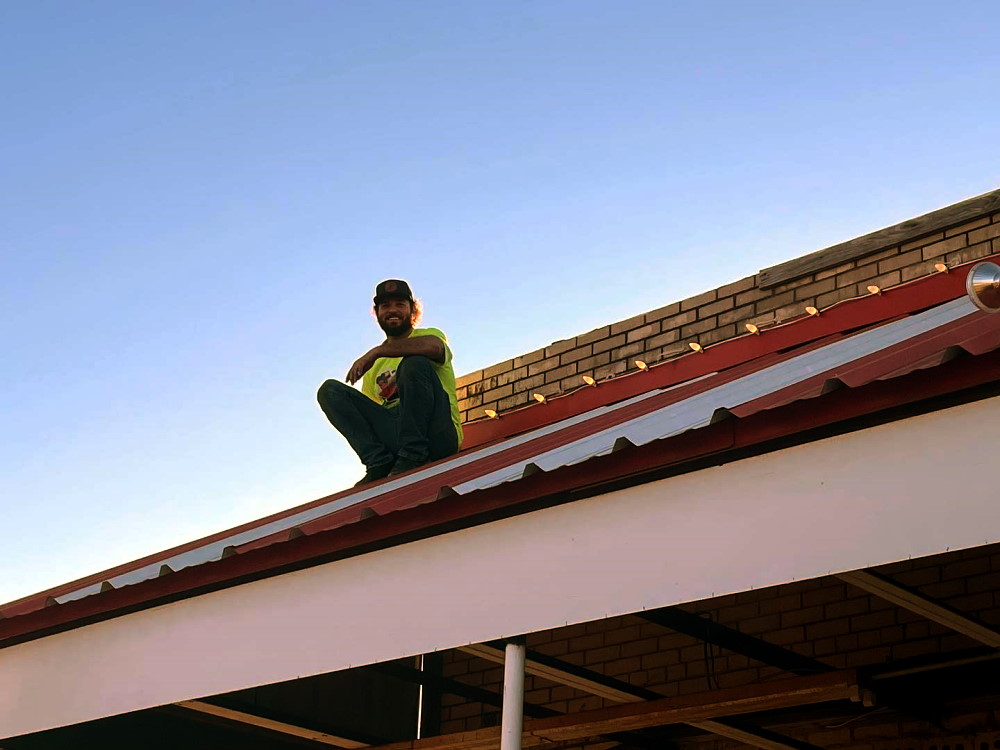 Caleb Stephens enjoying some solitude on a storefront rooftop while installing Christmas Lights Caleb Stephens enjoying some solitude on a storefront rooftop while installing Christmas Lights