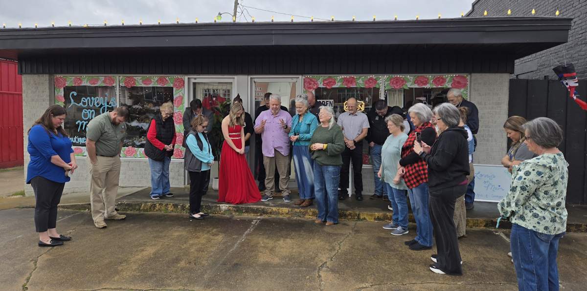 Lovey's on Main Ribbon Cutting Celebrating with a prayer from Mayor Ron Humphries